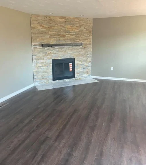 Finished basement with new flooring and fireplace after refinishing